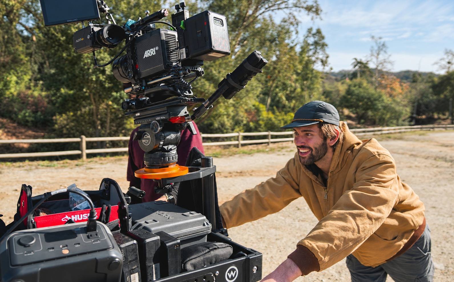 Toby Romero moving a camera cart on location