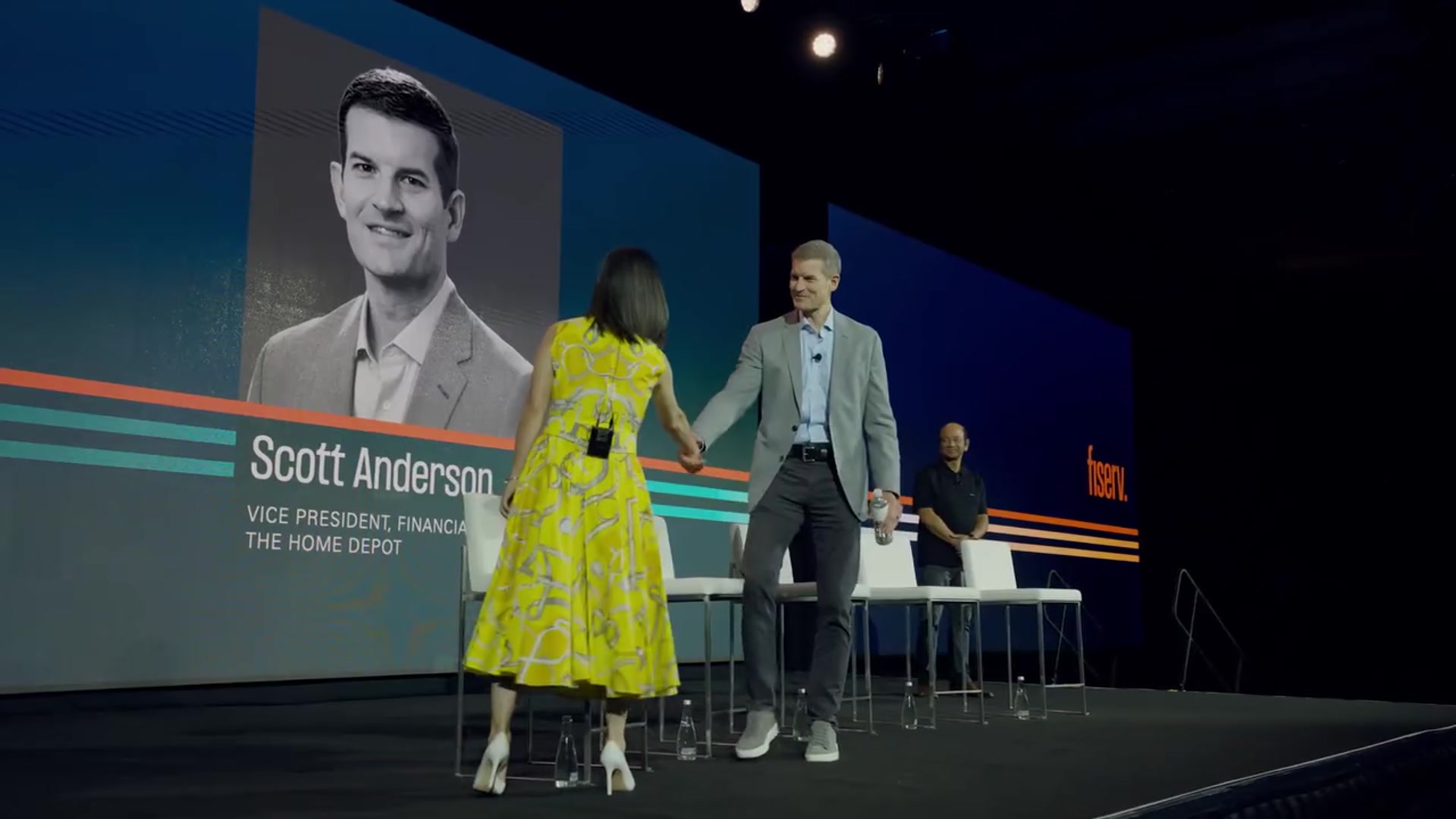 Two speakers on stage at Fiserv Forum