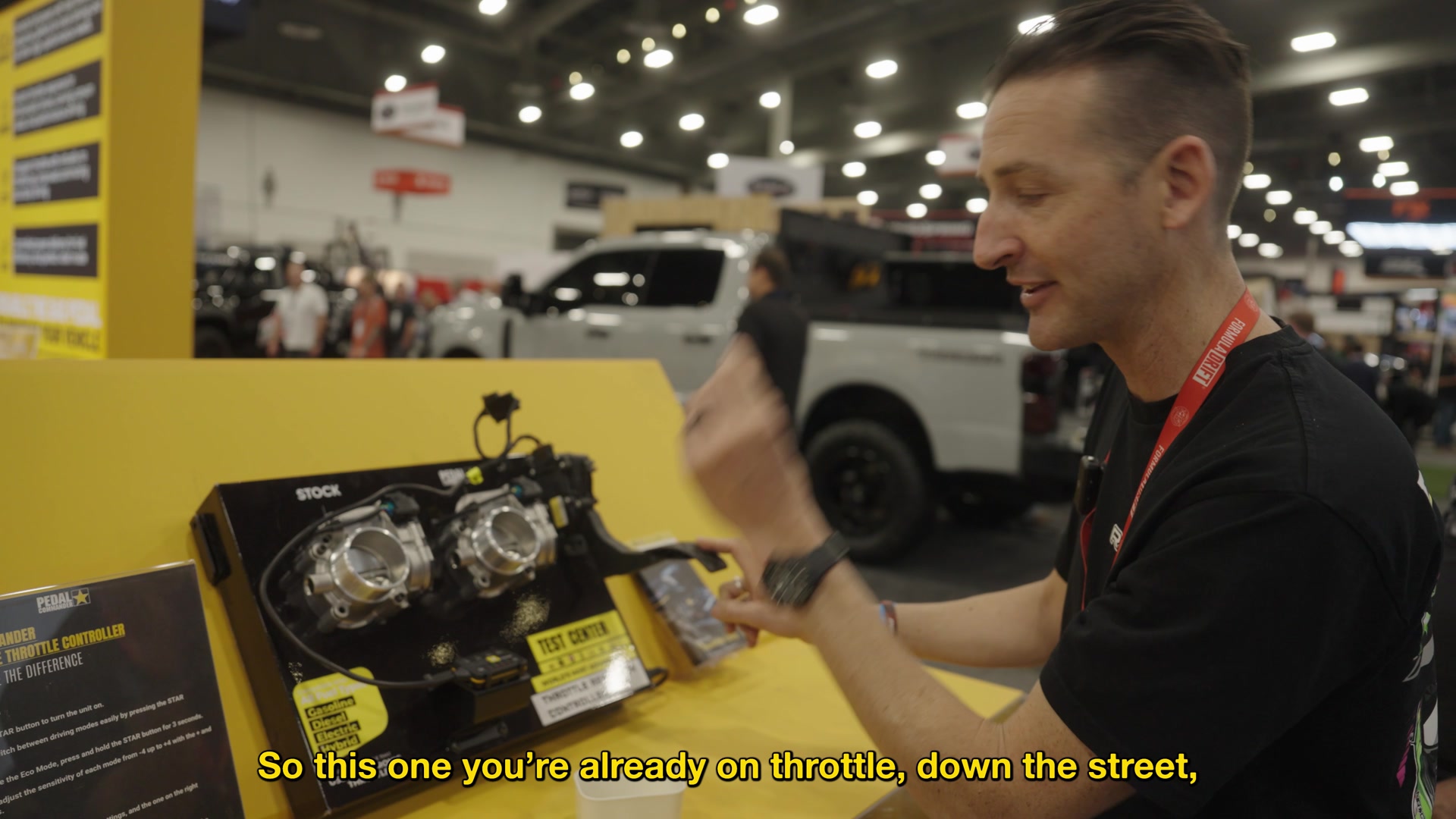 A presenter demonstrating Pedal Commander at SEMA